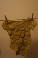 The weight of responsibility- stones stitched into baby grow